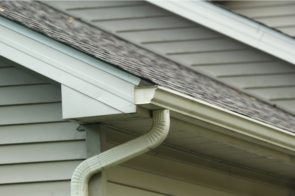 A gutter on the side of a suburban home